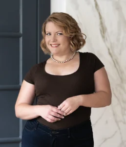 Photo of Neurodiversity and Neurodivergence Speaker Kristin Light. She is wearing a vintage brown dress and pearls.